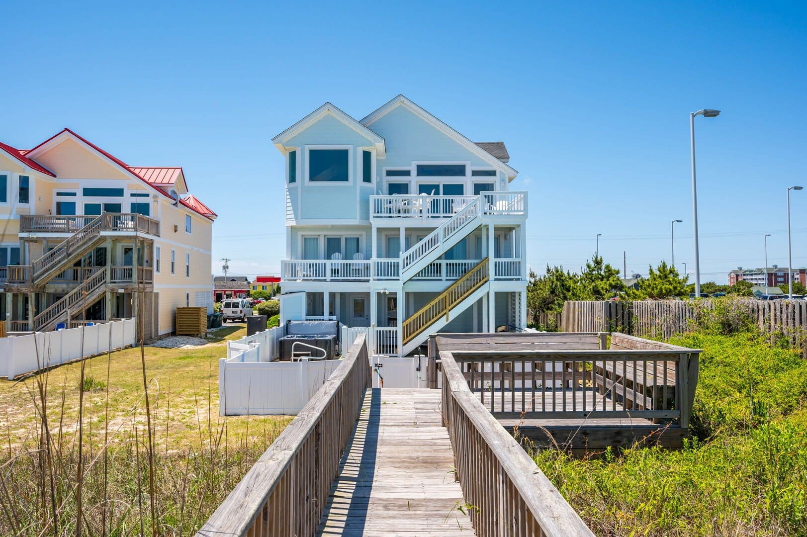 Beach house with wooden walkway.