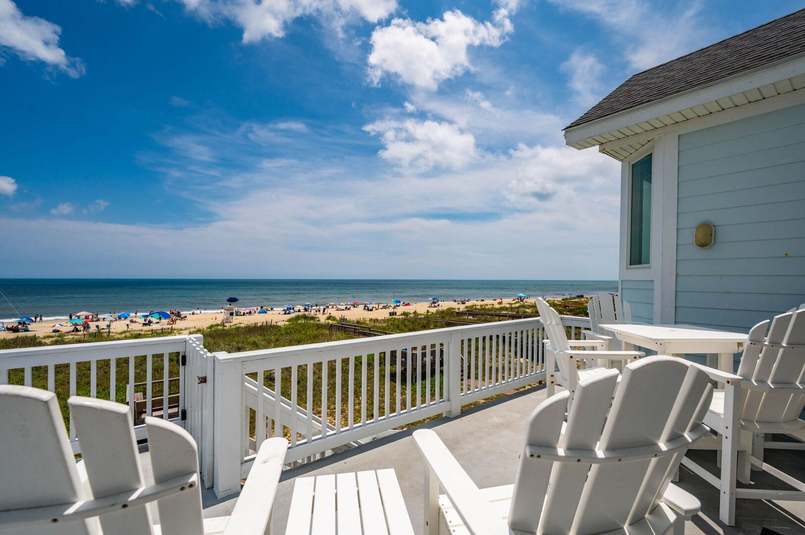 Beachfront view from wooden deck.