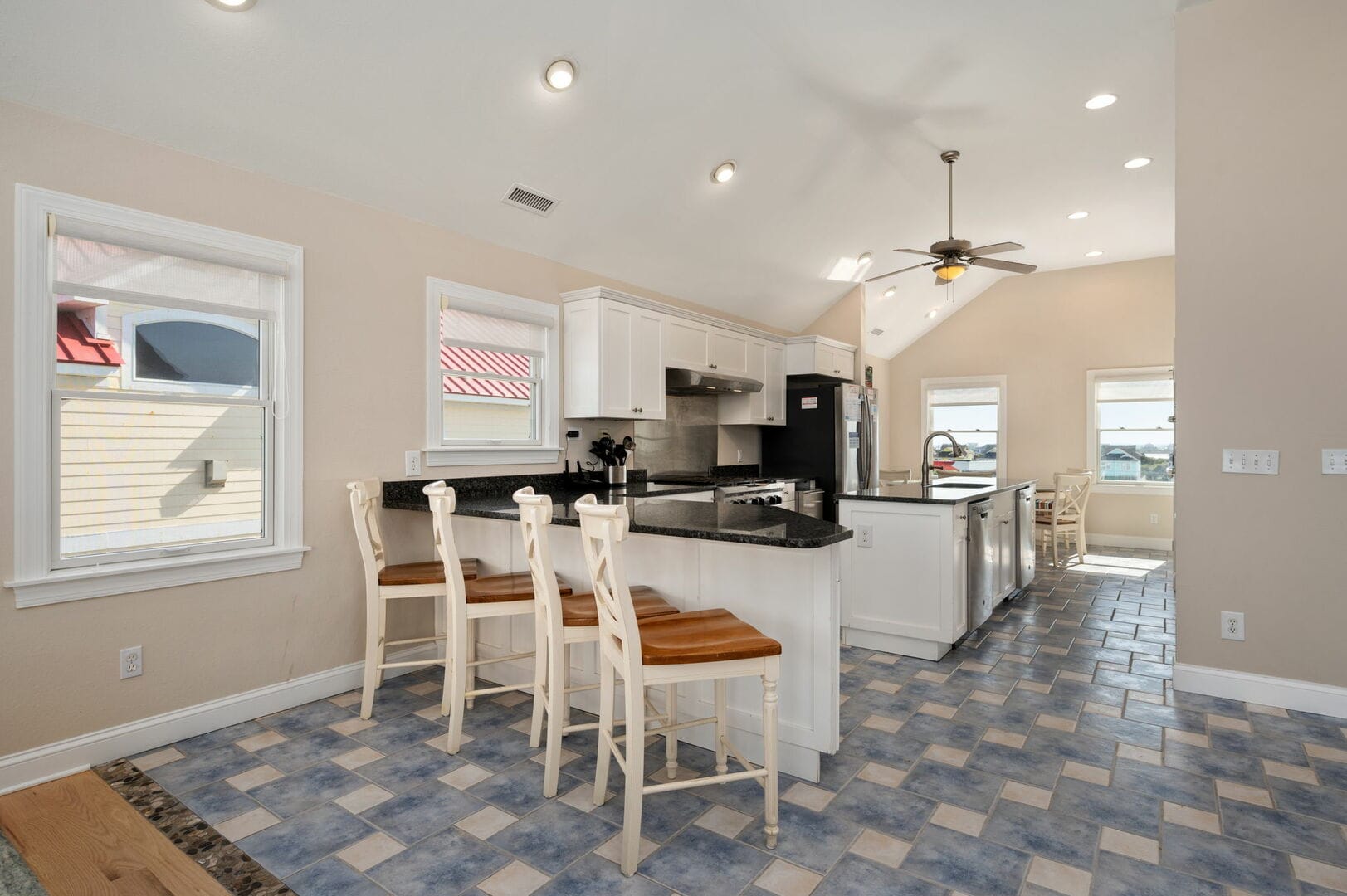 Modern kitchen with island and chairs.