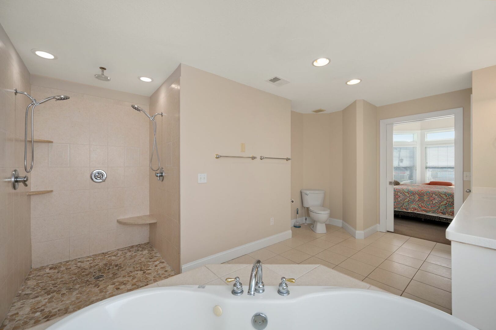 Spacious bathroom with shower area.