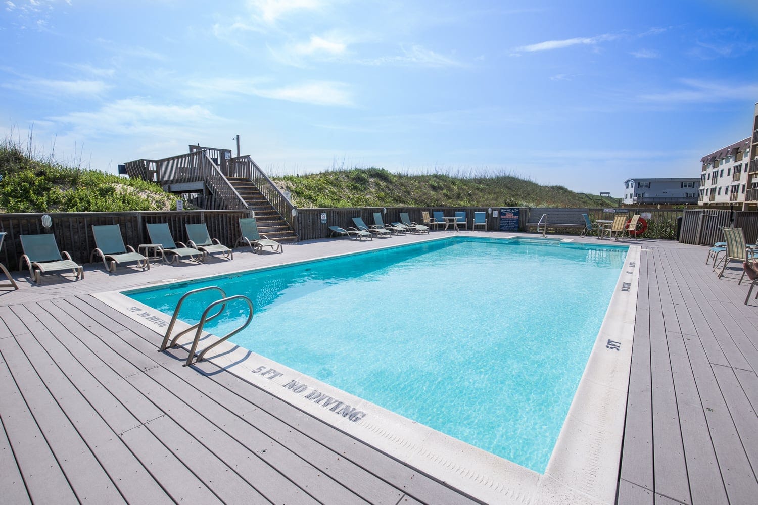 Outdoor pool with lounge chairs.