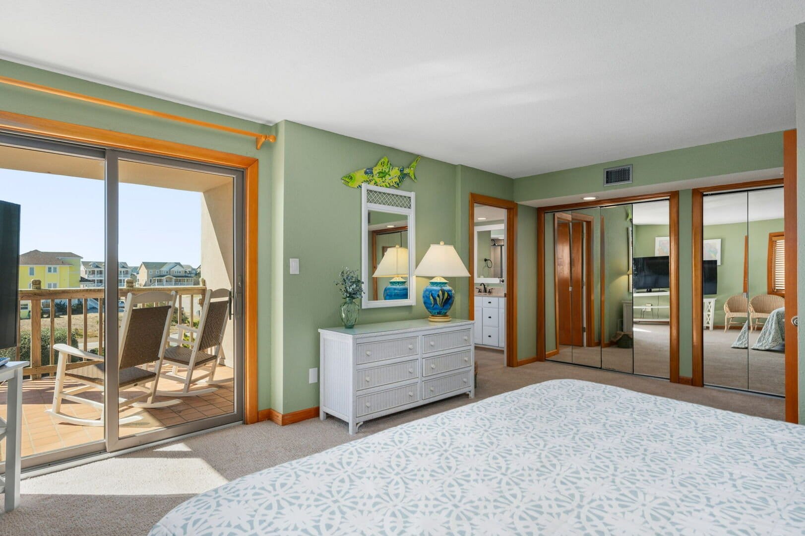 Green bedroom with balcony view.