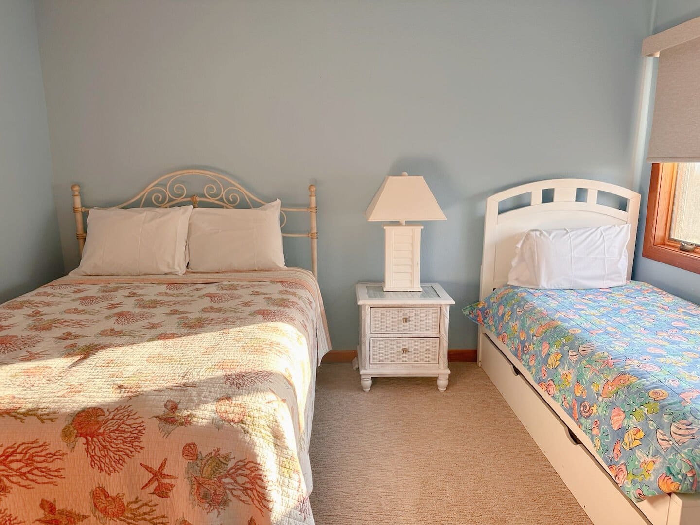 Bedroom with two beds, lamp.