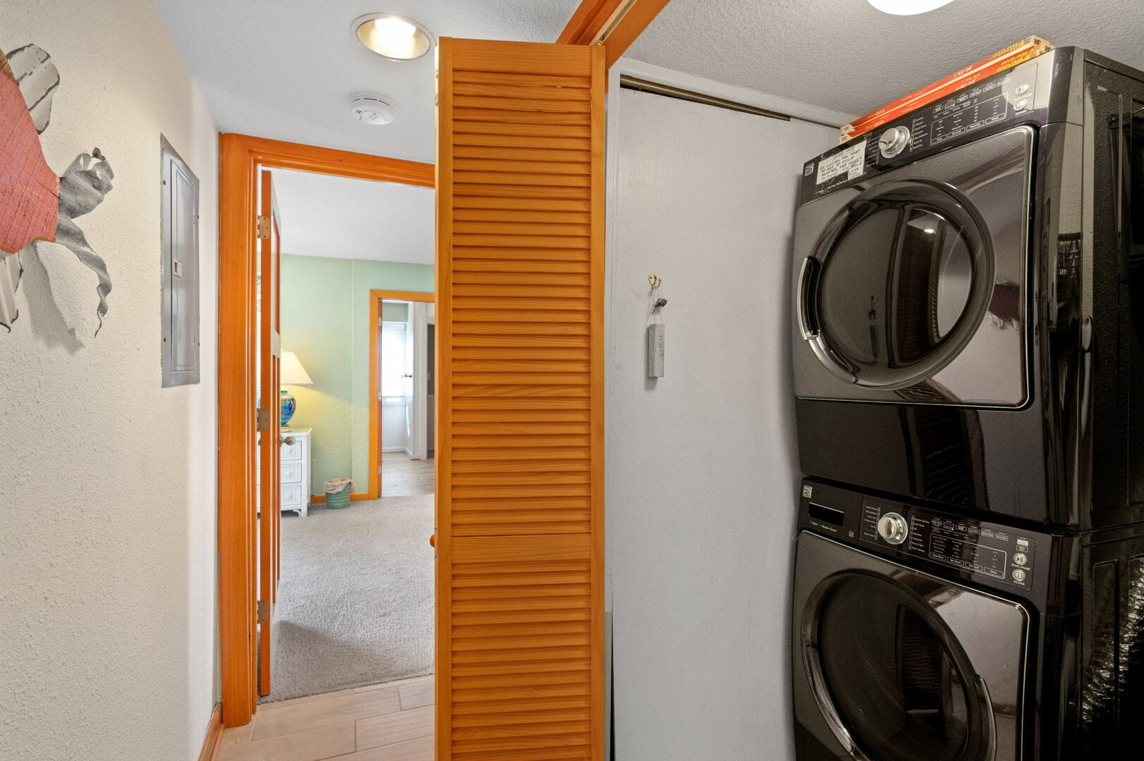 Hallway with stacked washer dryer.