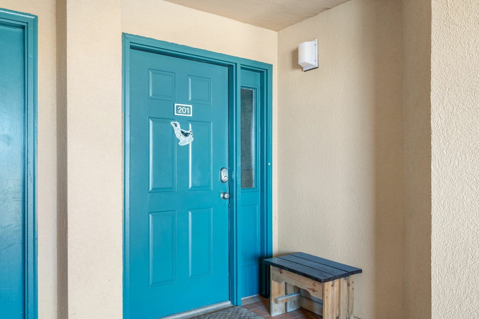 Blue door with wooden bench.