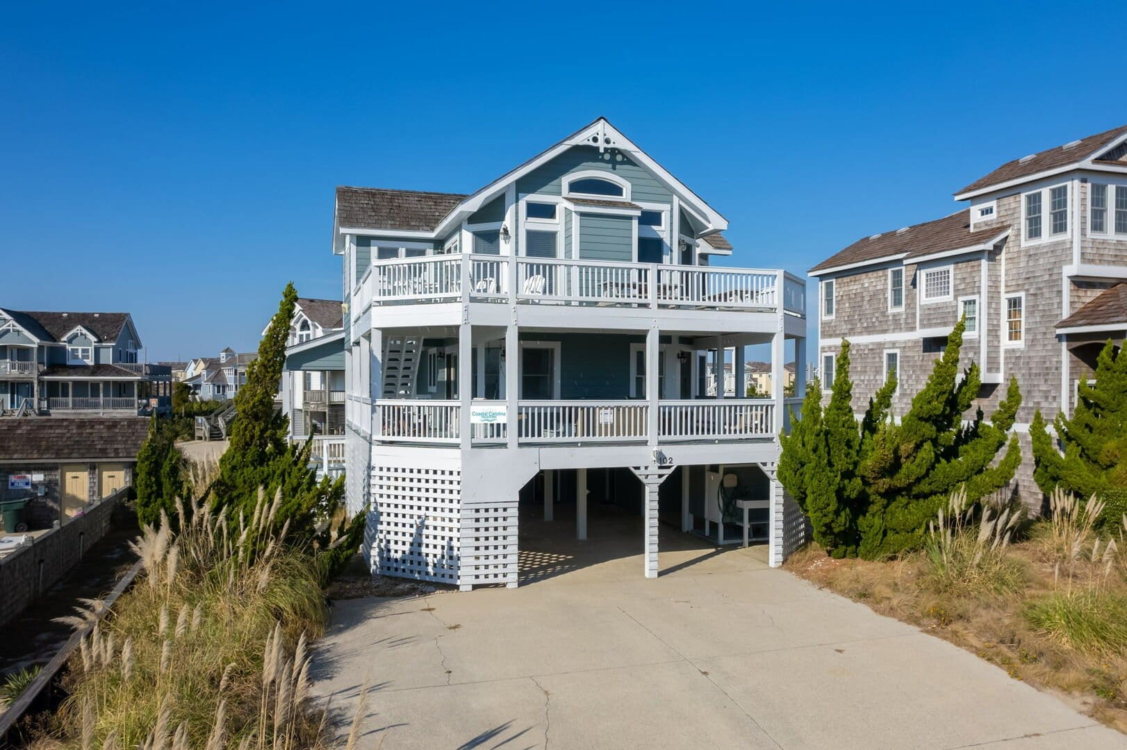 Two-story beach house with balcony.