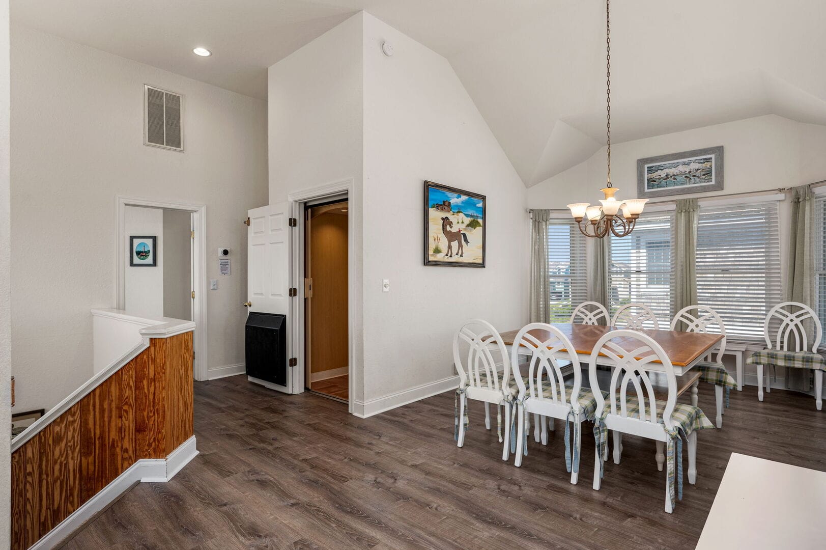 Bright dining room with wooden flooring.