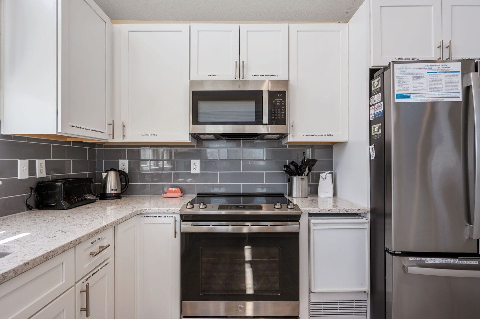 Modern kitchen with stainless steel appliances.