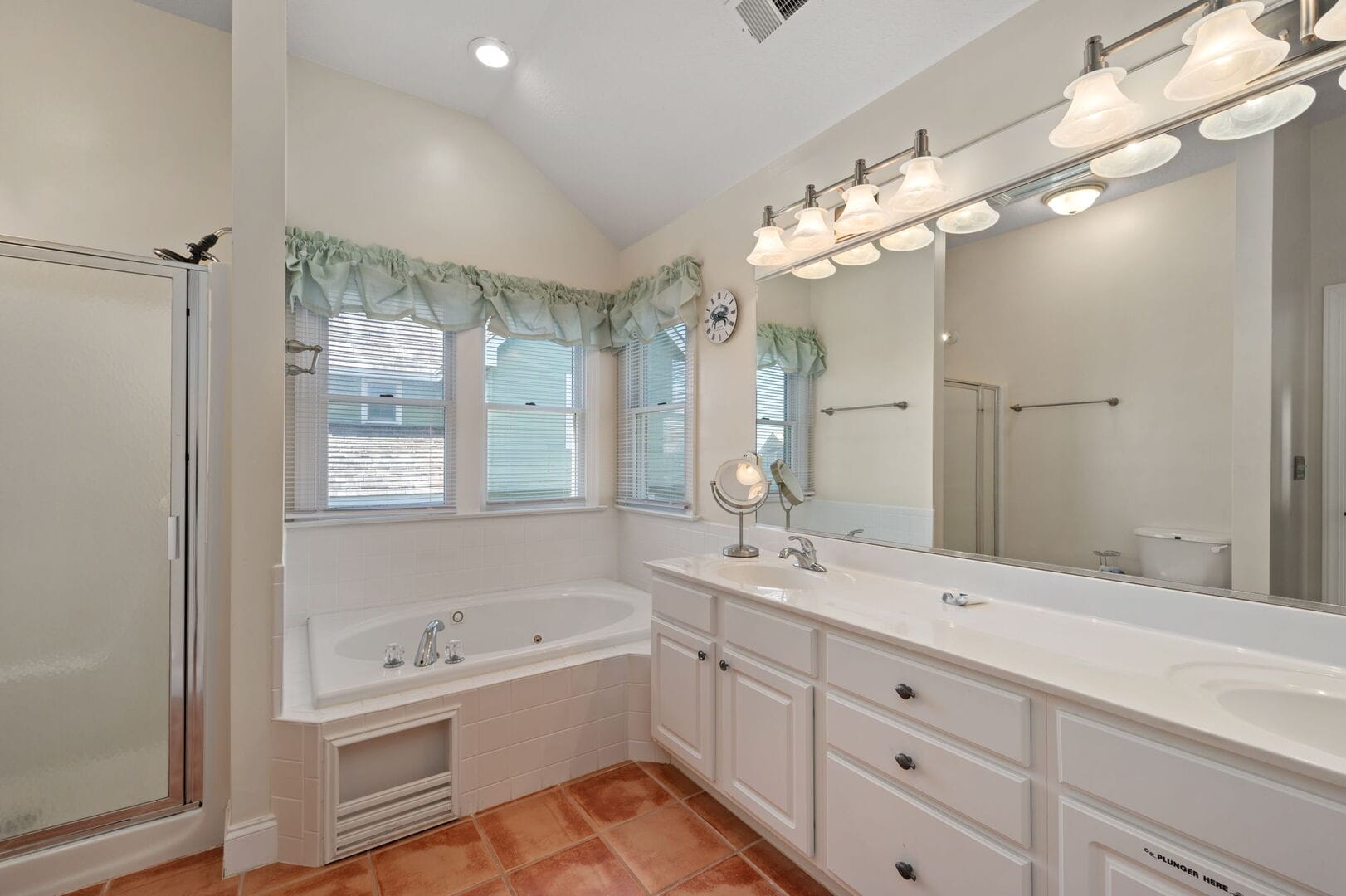 Bright bathroom with tub and vanity.