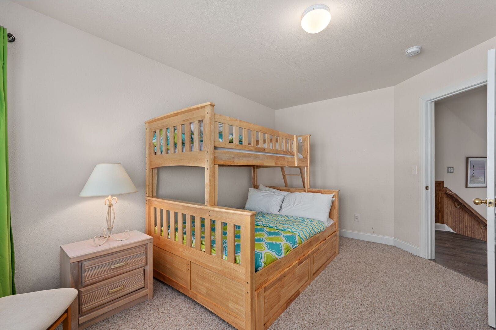 Wooden bunk bed, bedside lamp.
