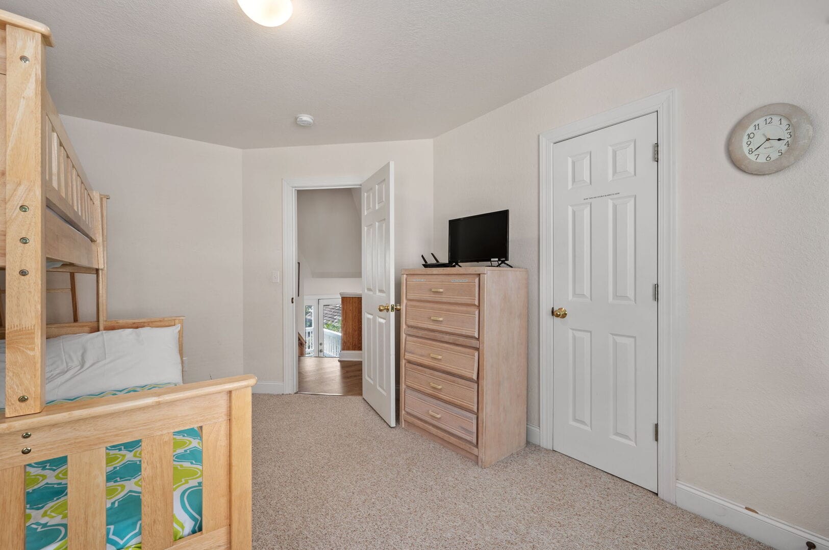 Bedroom with bunk bed and dresser.