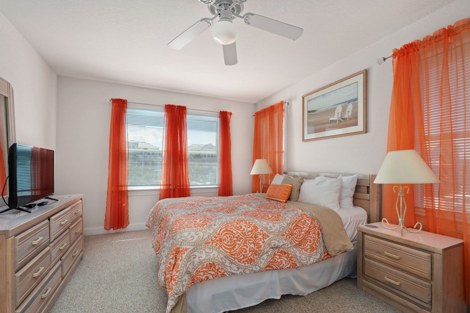 Bright bedroom with orange accents.