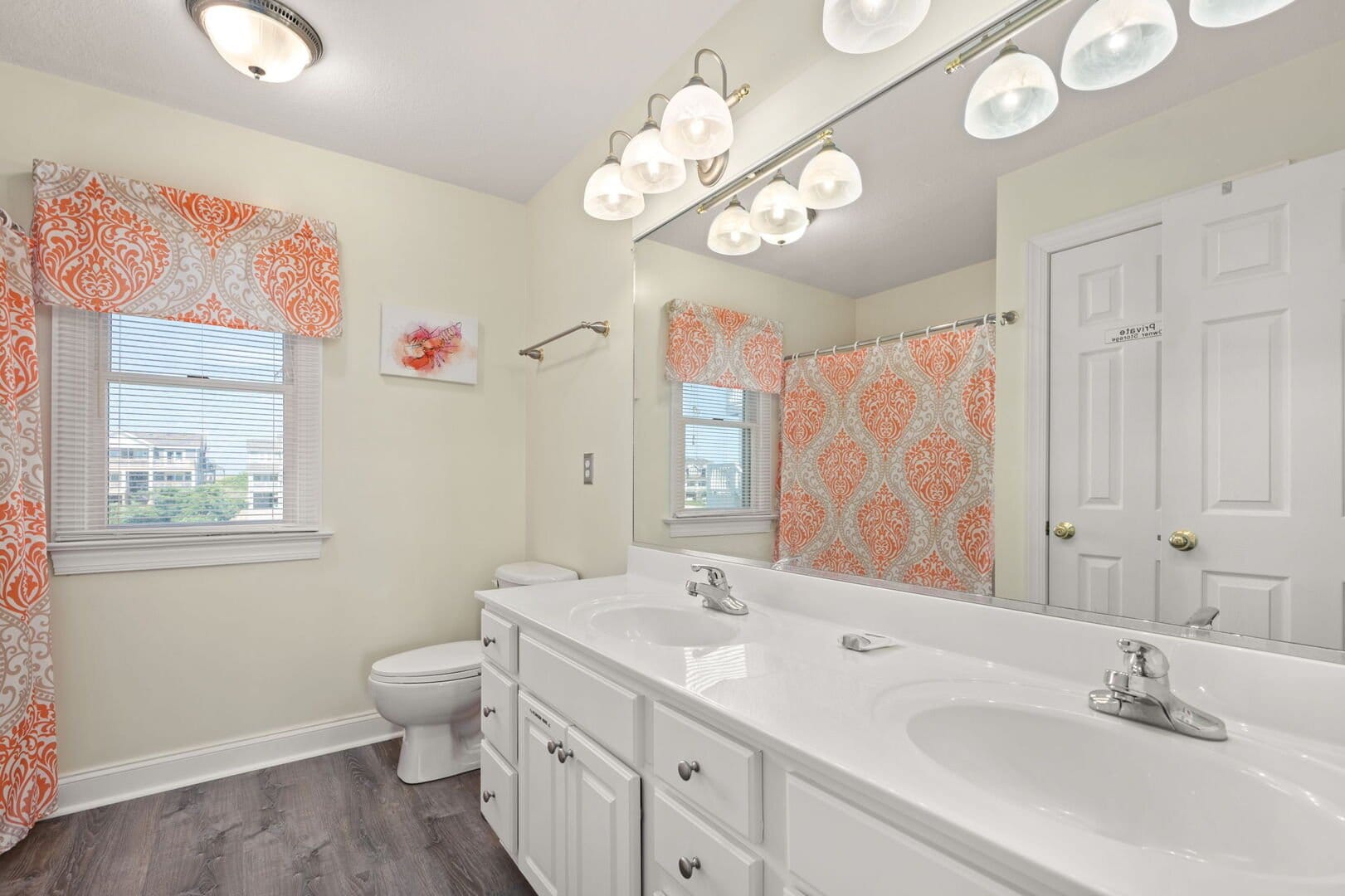 Bright bathroom with orange accents.