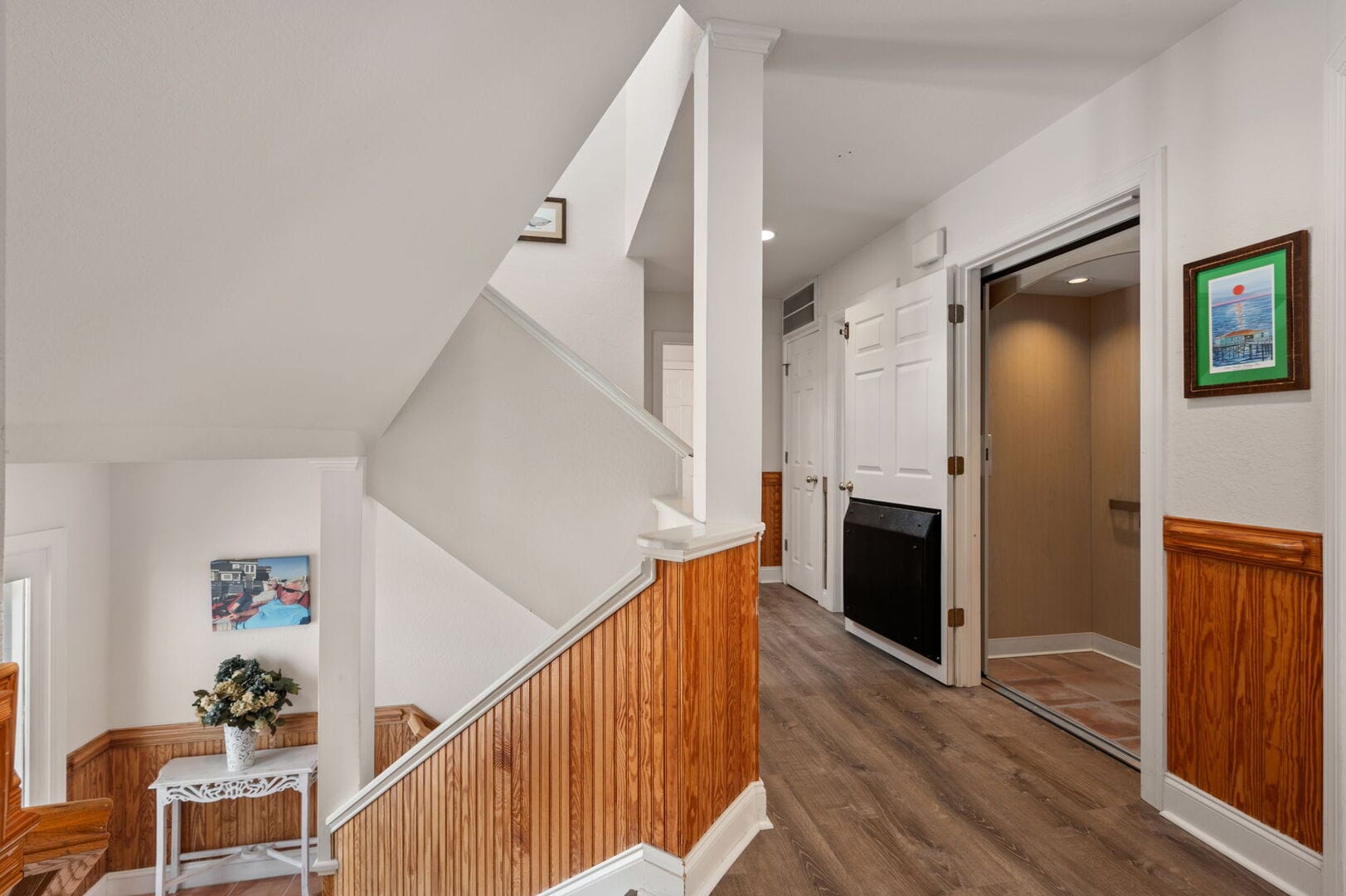 Staircase and hallway with elevator.