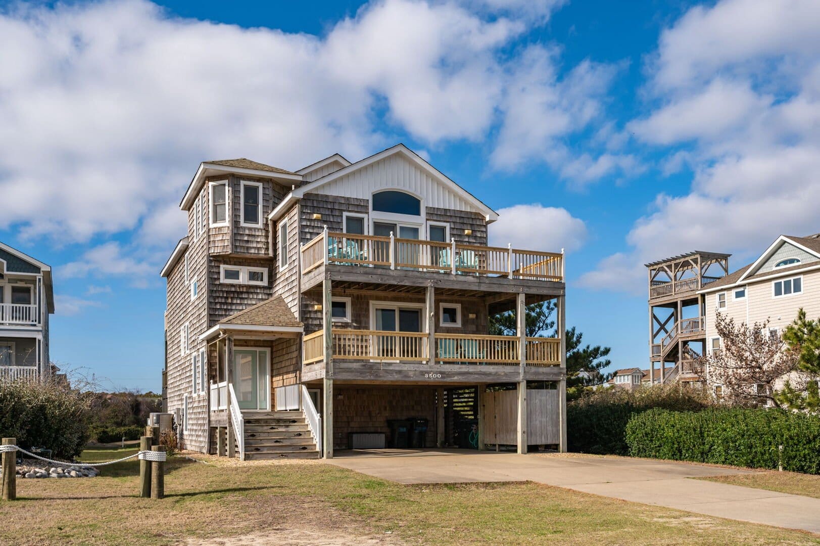 Three-story beach house with deck.
