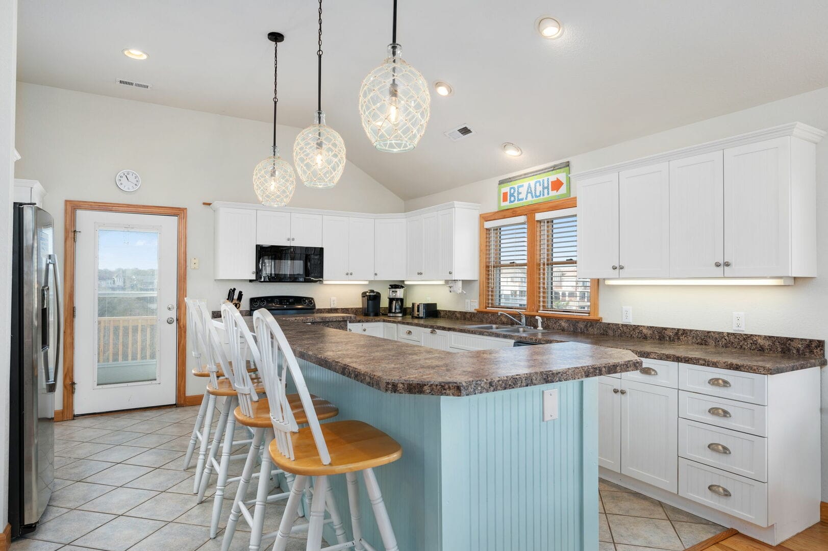 Bright kitchen with bar stools.