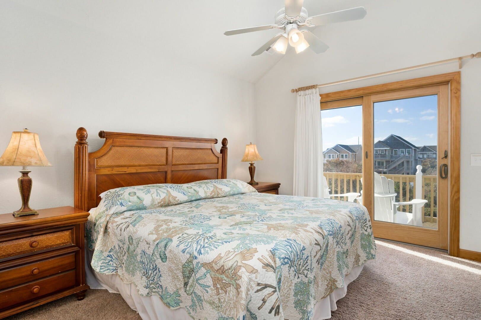 Bedroom with balcony and ceiling fan.