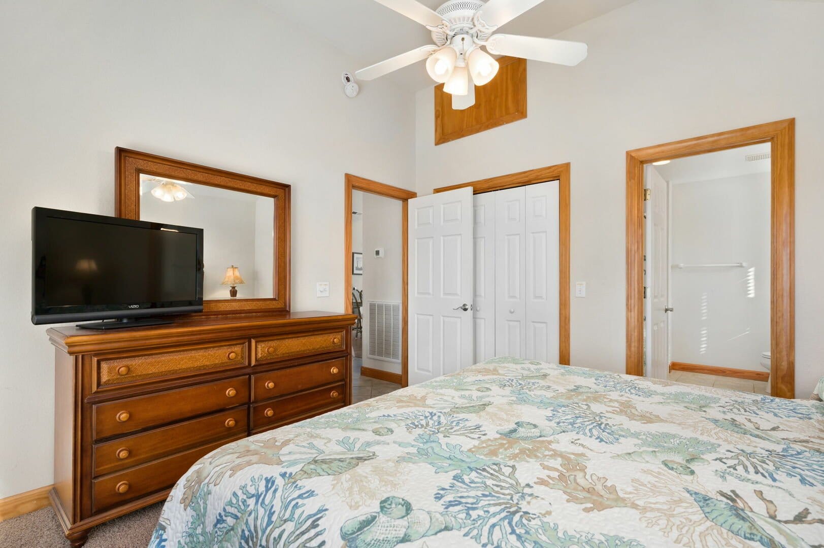 Bedroom with dresser and TV.