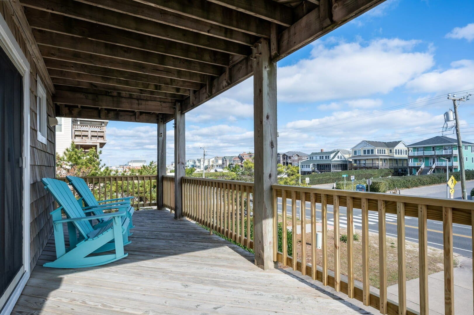 Wooden porch with rocking chairs.