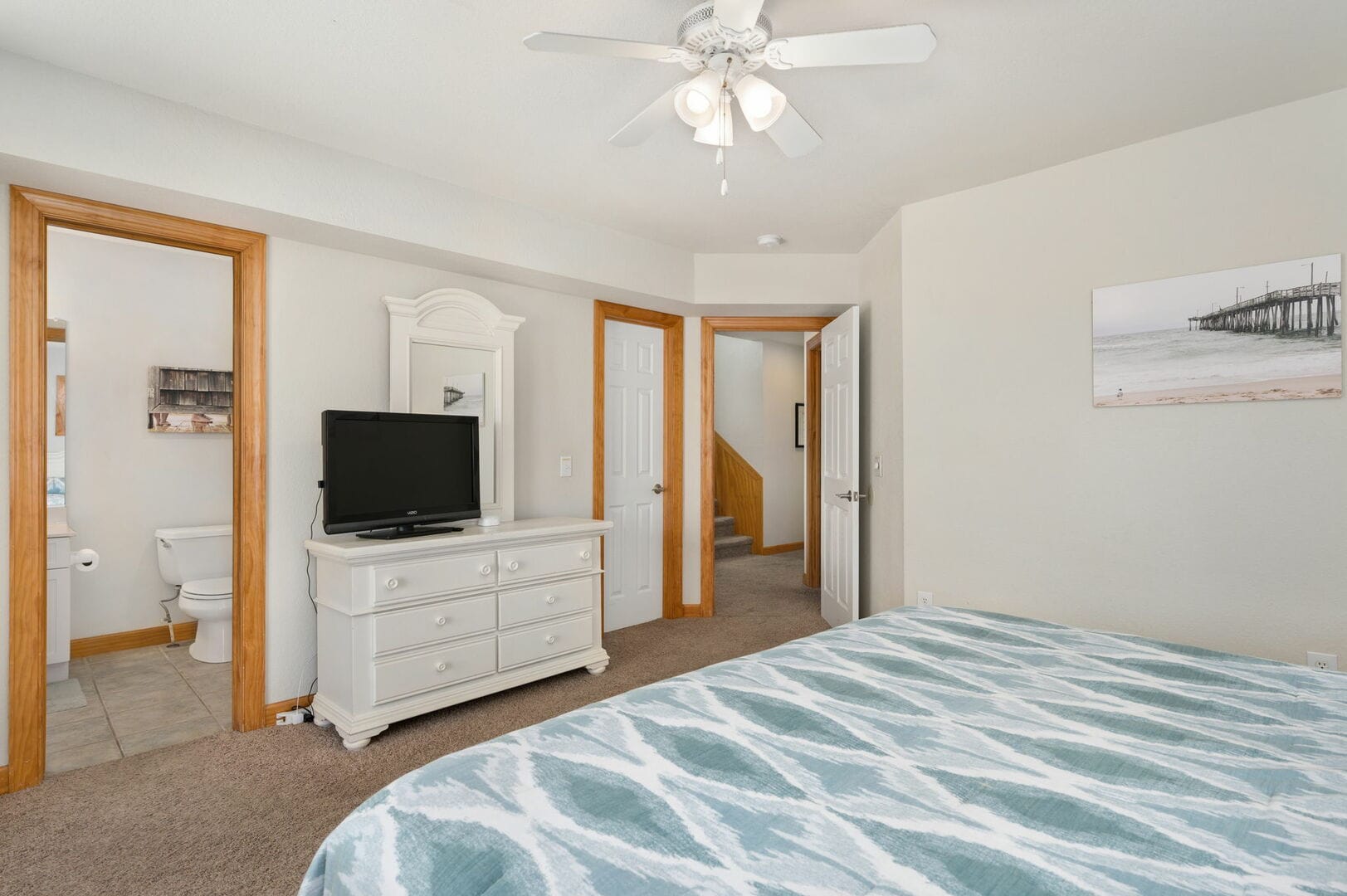 Bedroom with dresser and TV.