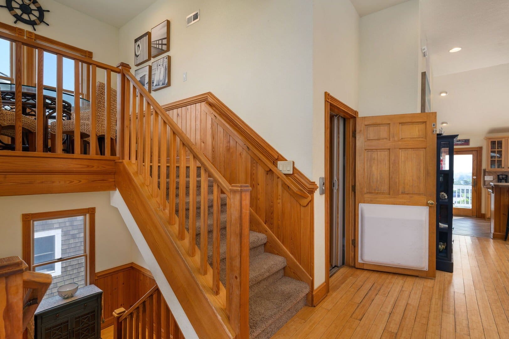 Wooden staircase and open door.