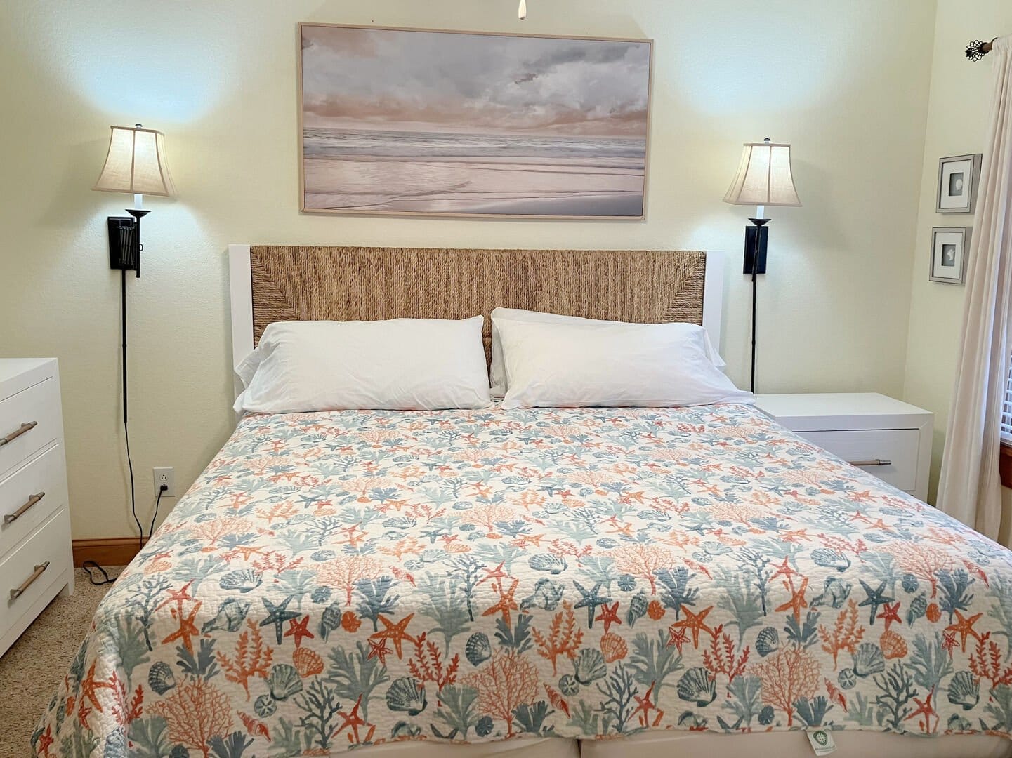Bed with sea-themed quilt.