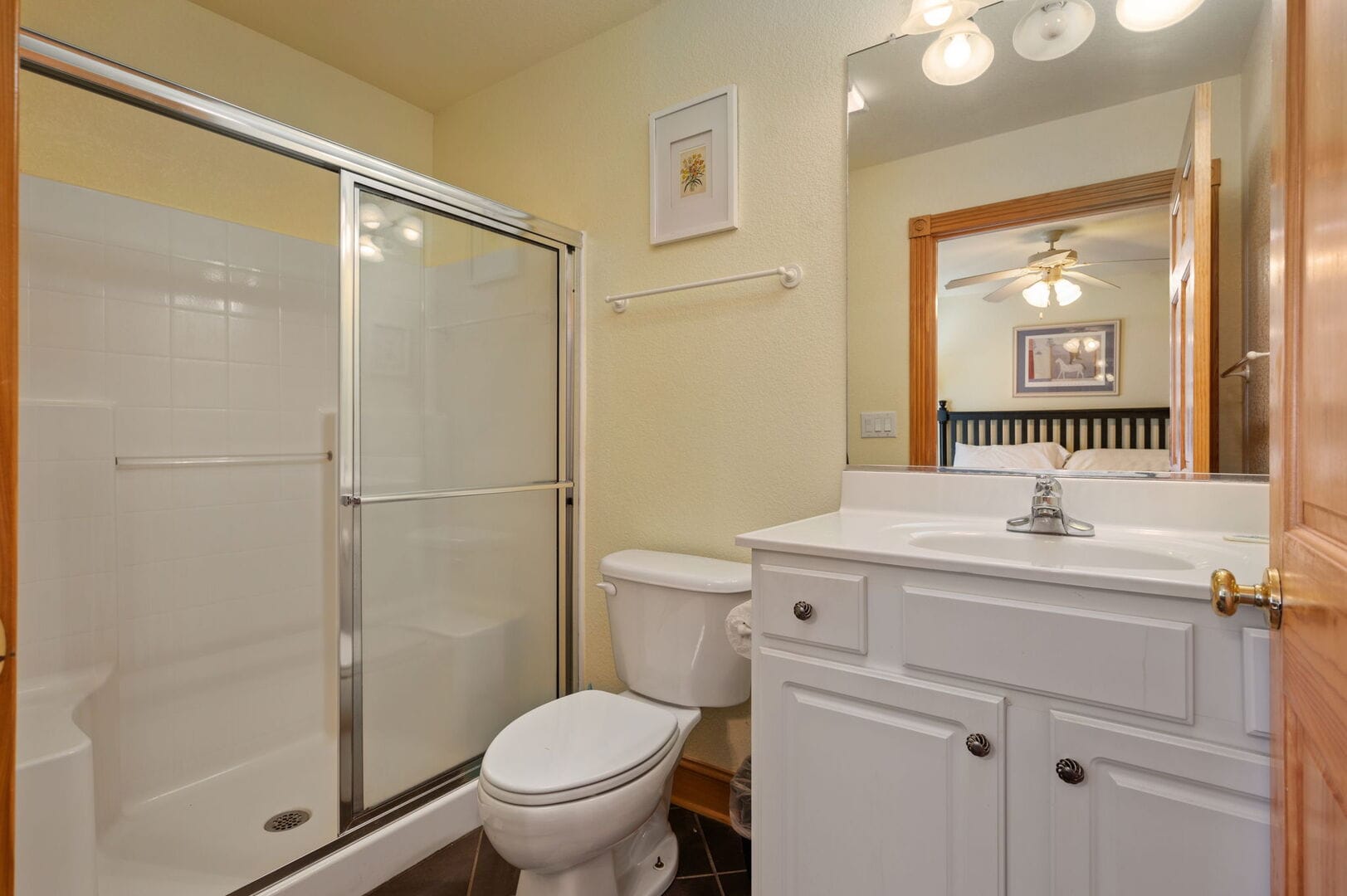 Small bathroom with shower, mirror.