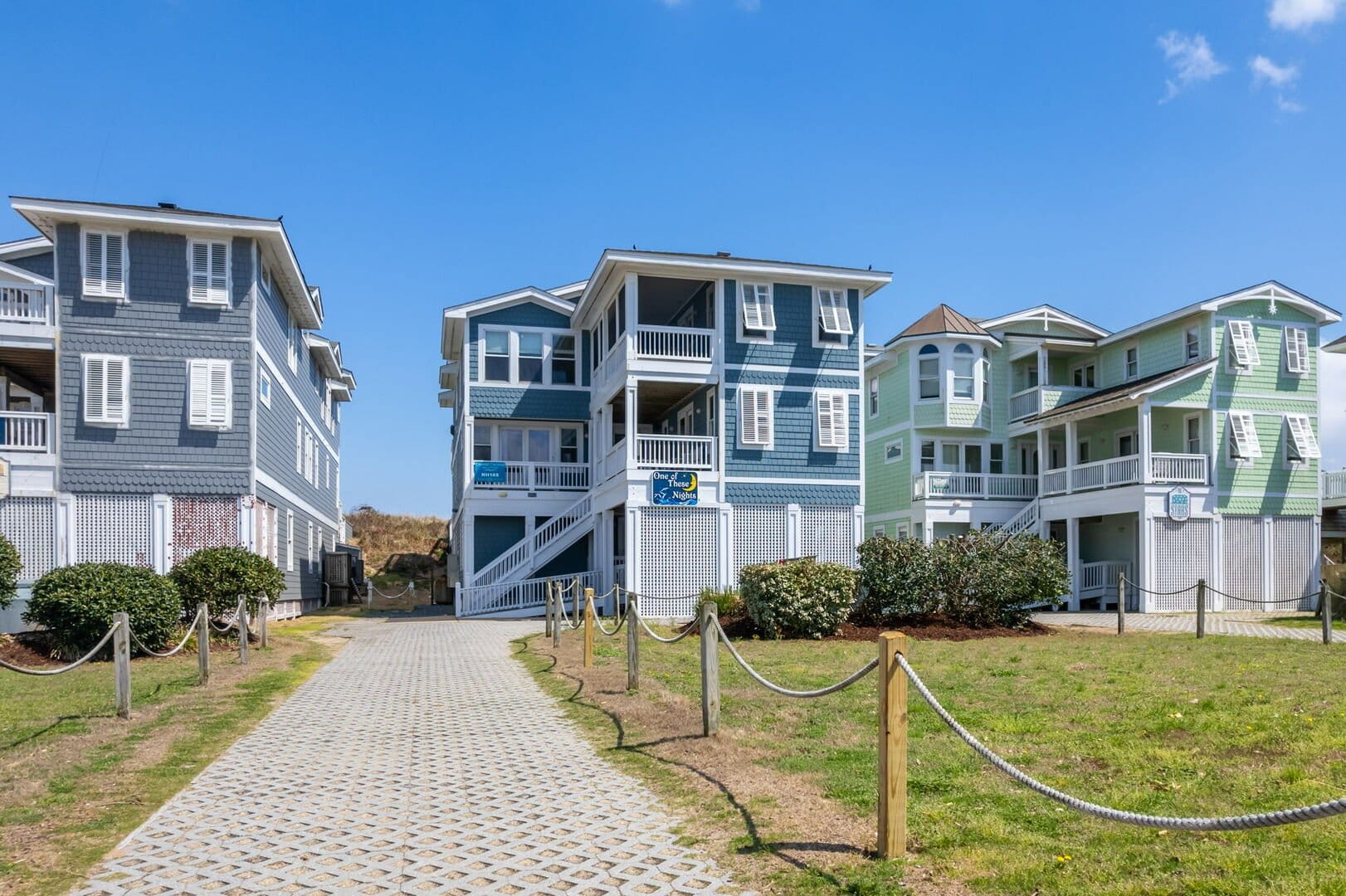 Colorful beach houses under blue sky.