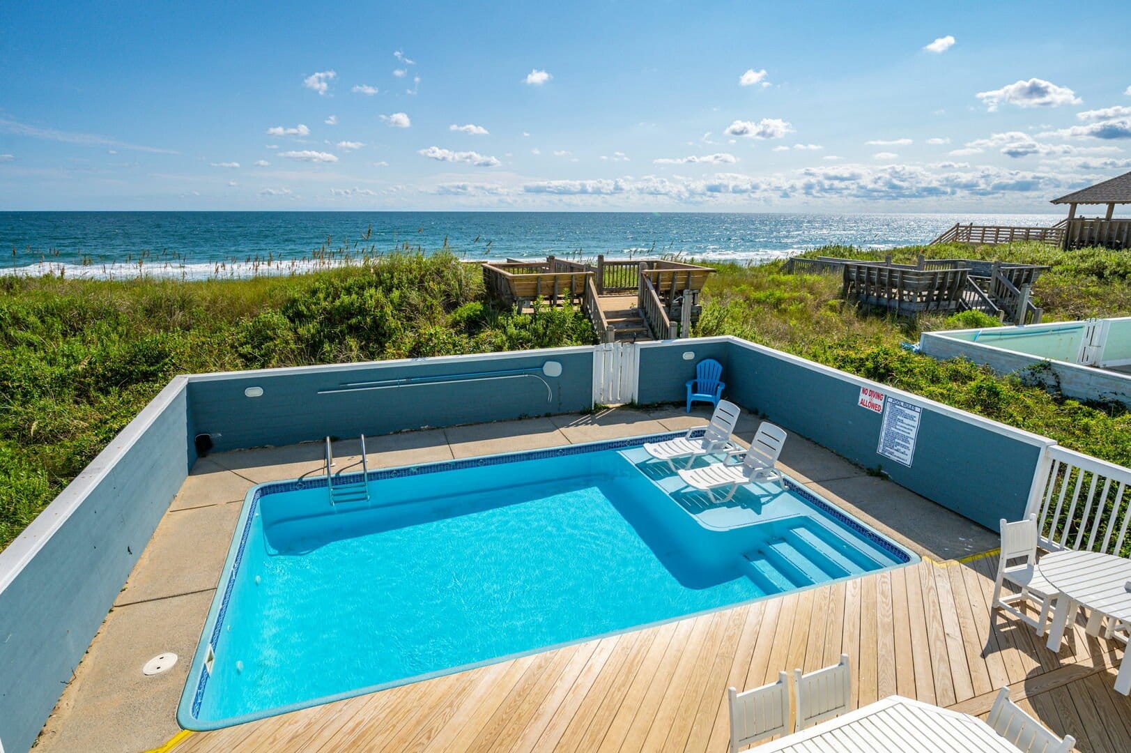 Pool overlooking beach and ocean.