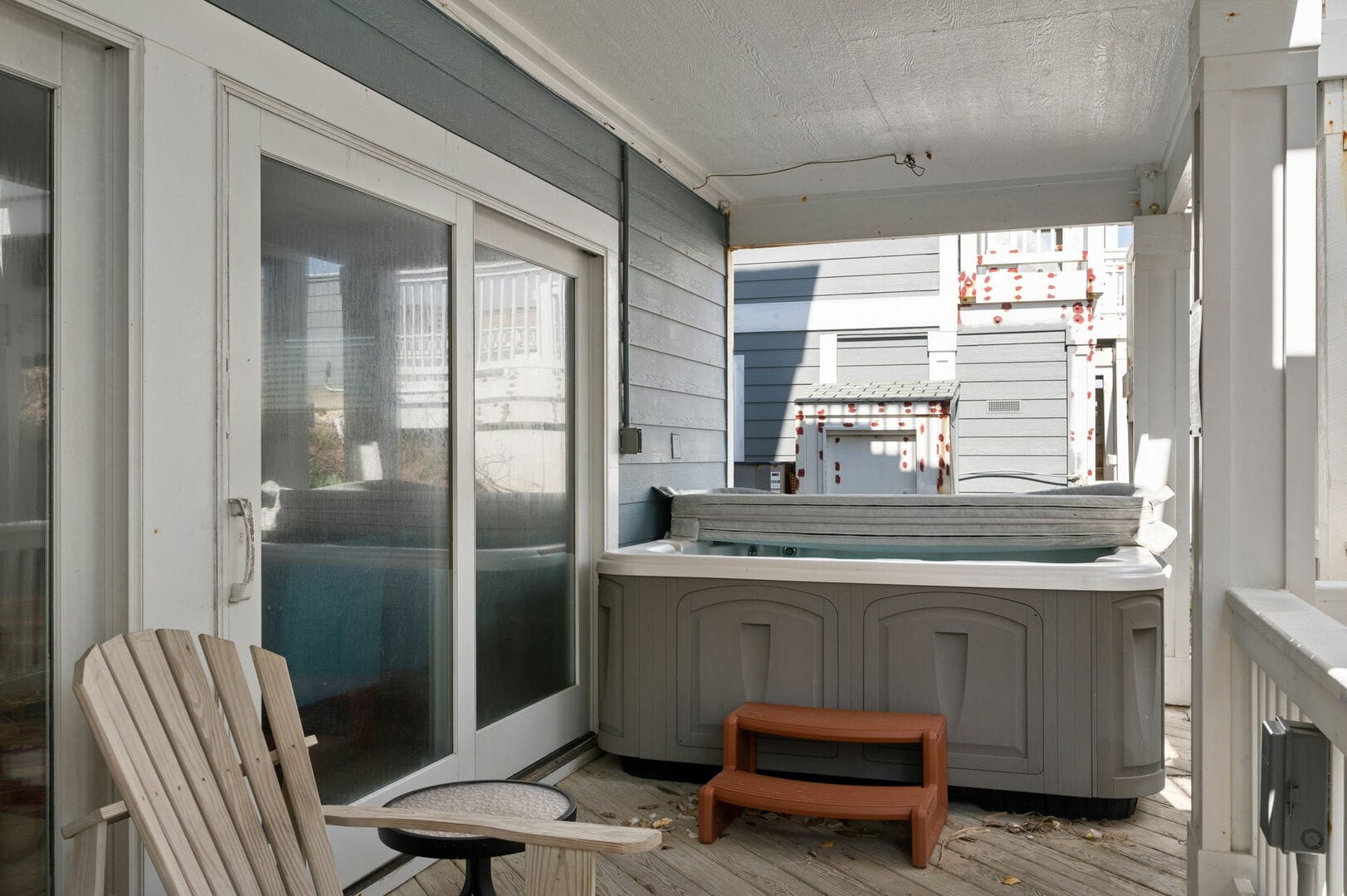 Covered patio with hot tub.