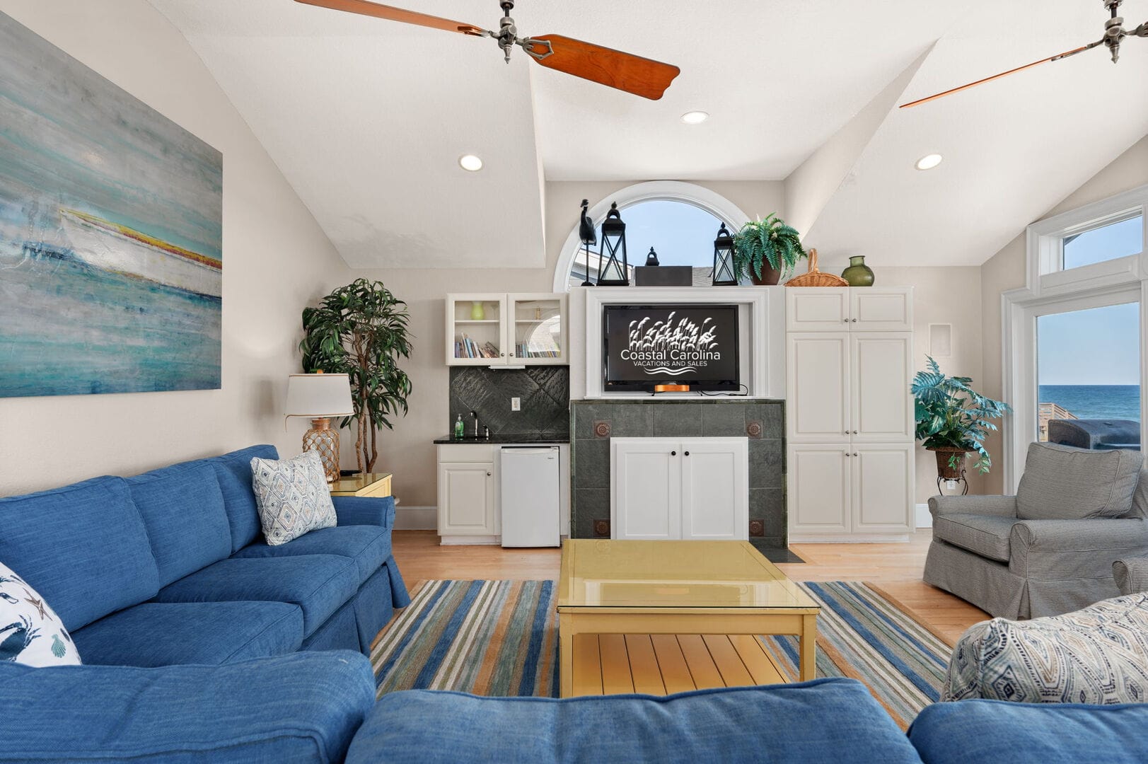 Coastal-themed living room with ocean.
