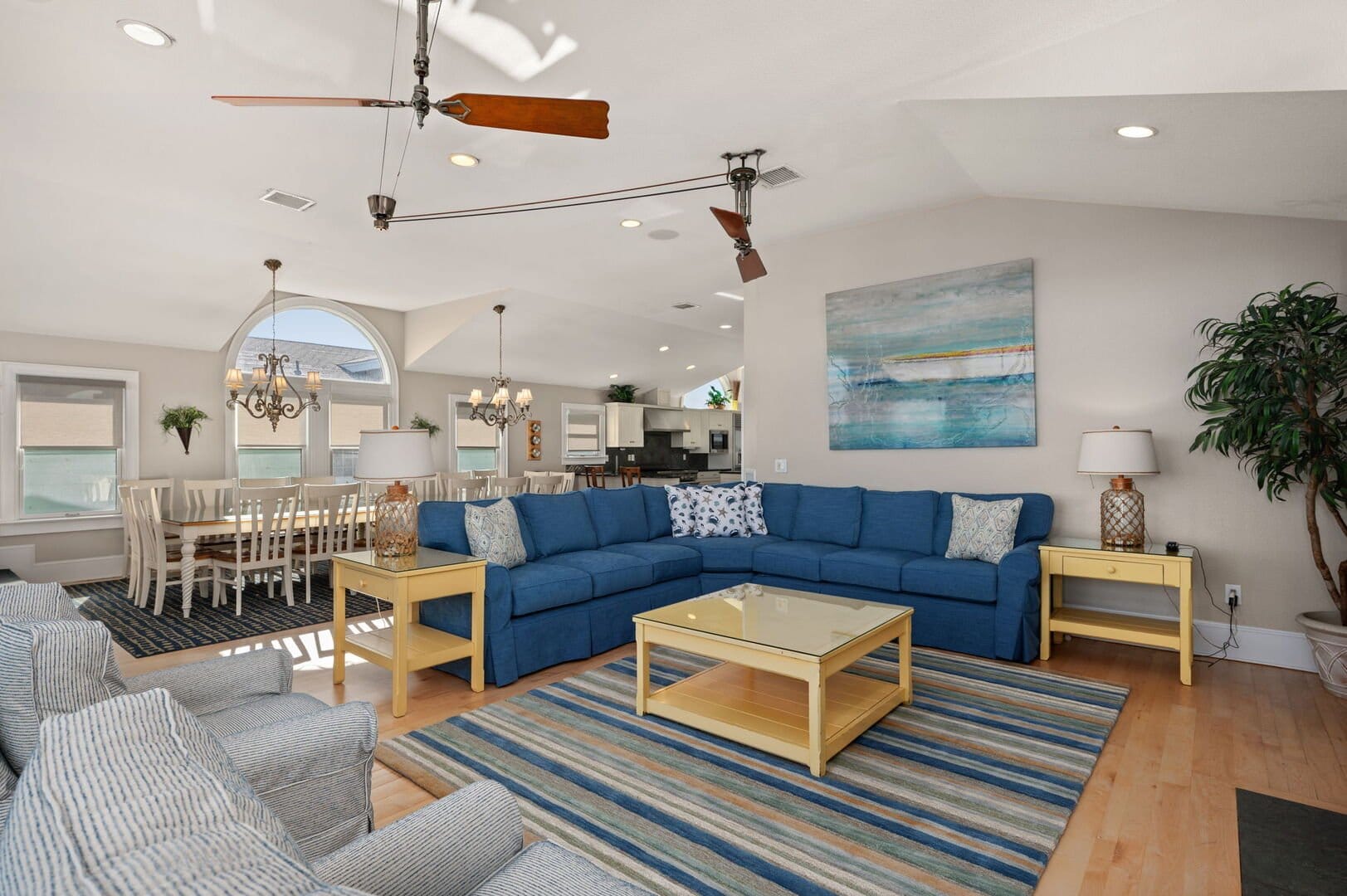 Spacious living room with blue couch.