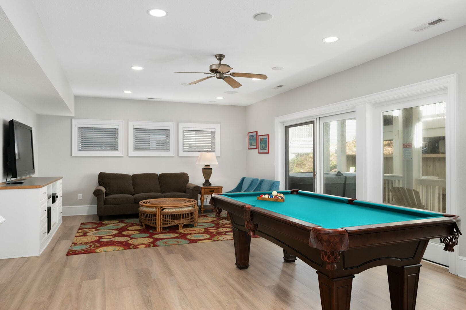 Room with pool table and couch.