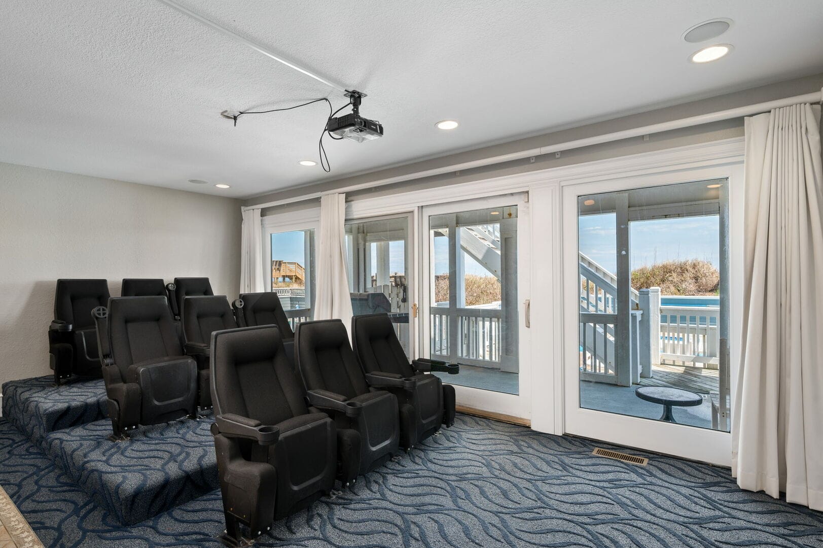Home theater with black seats.