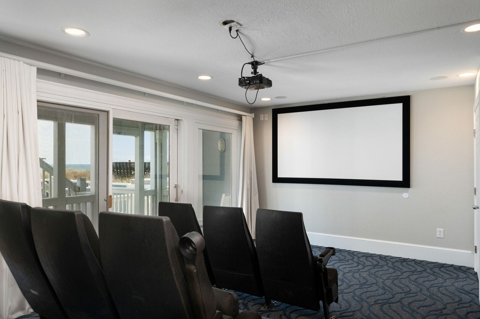 Home theater room with projector.