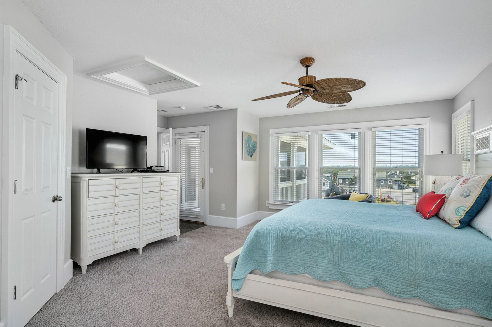 Bright bedroom with ceiling fan.