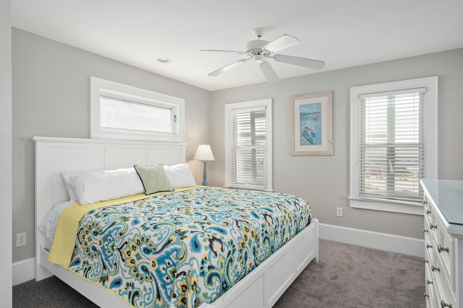 Bright bedroom with patterned bedspread.