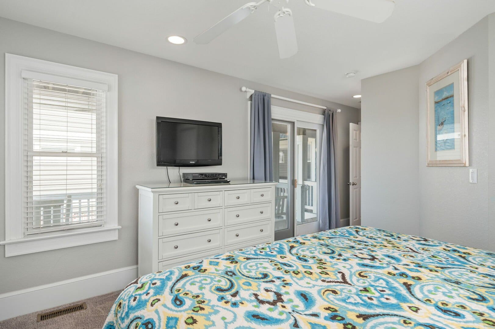 Bedroom with TV and dresser.