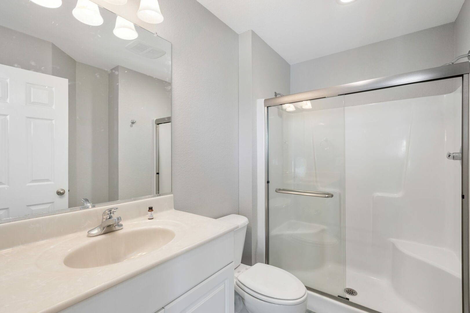 Modern bathroom with shower and sink.