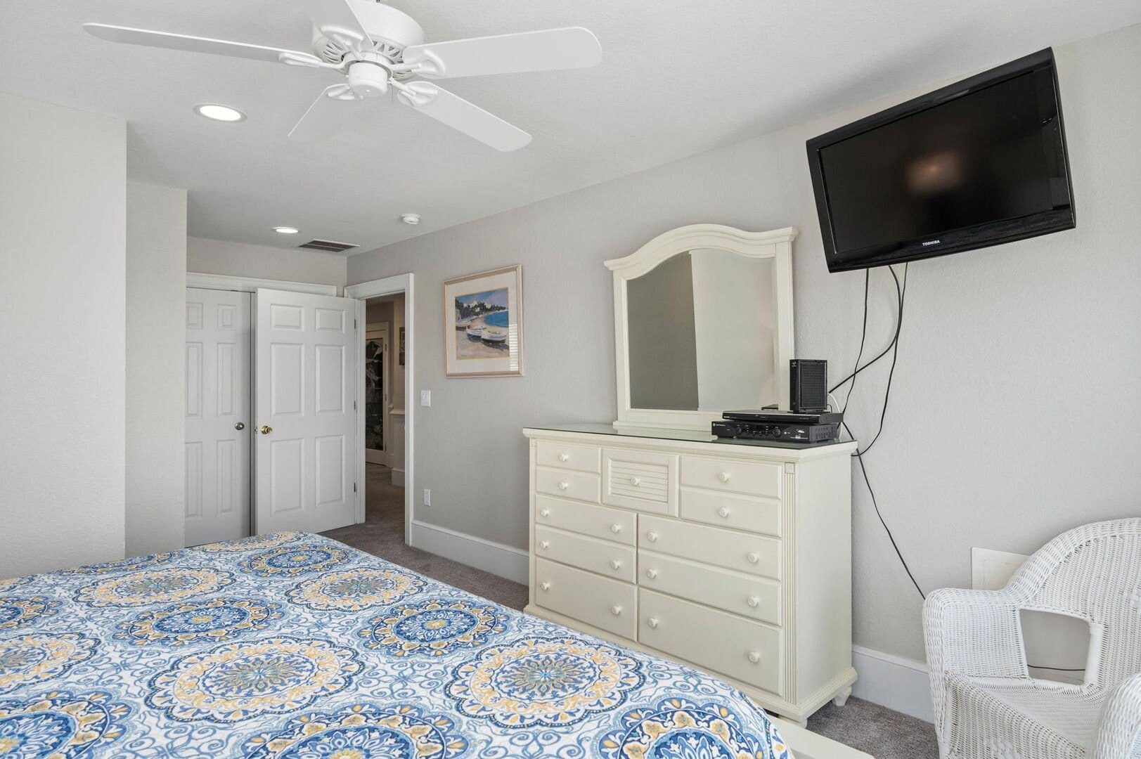 Bedroom with dresser and TV.