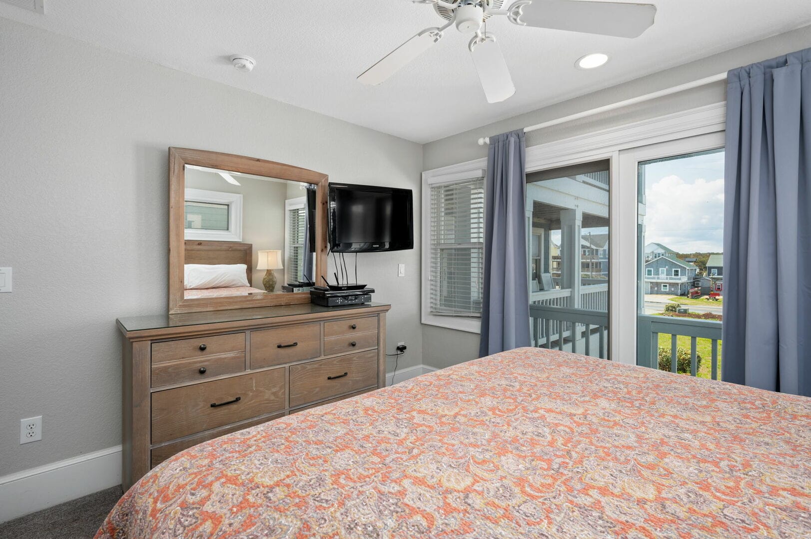 Bedroom with dresser and window.
