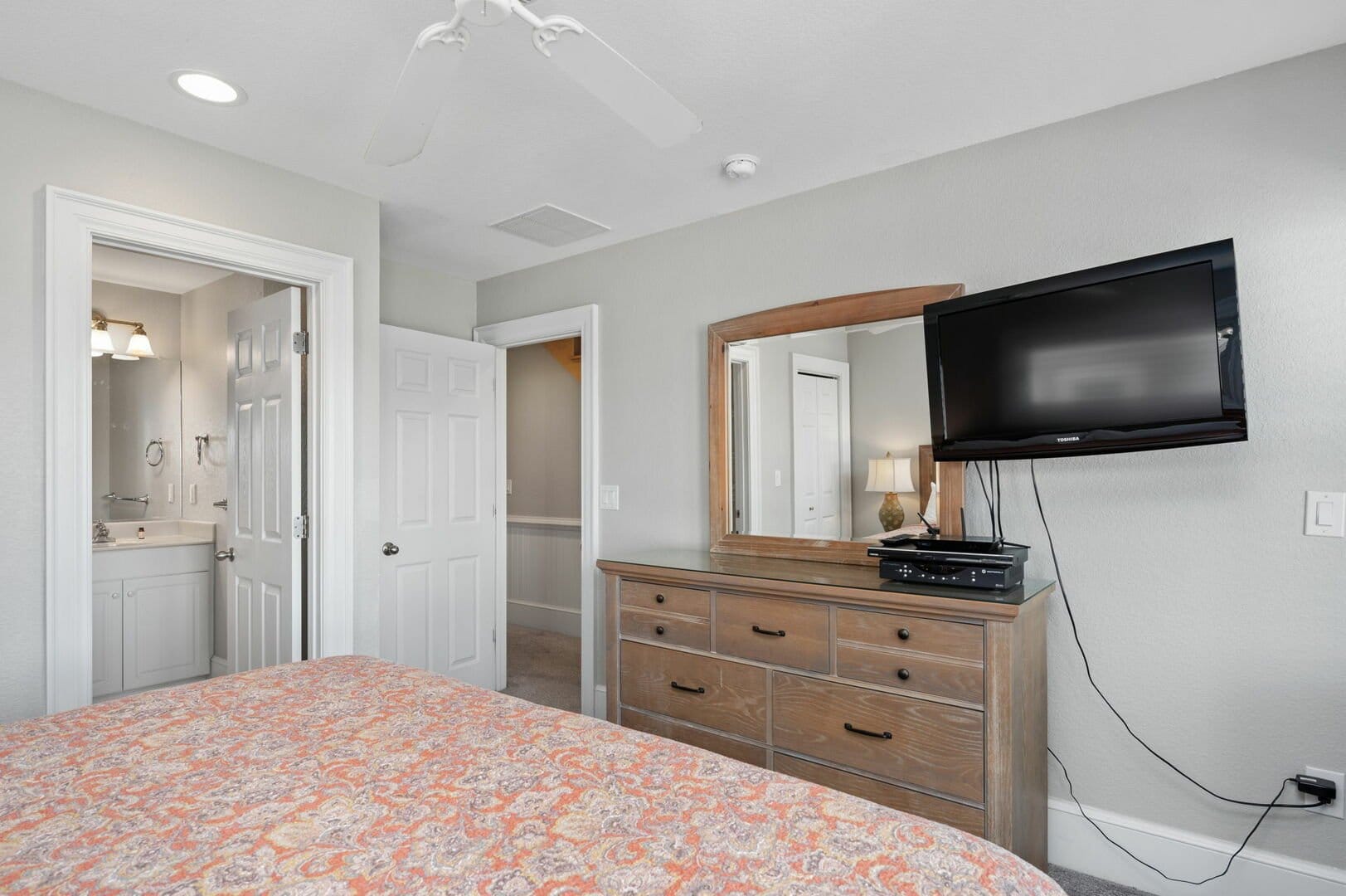 Bedroom with dresser and TV.