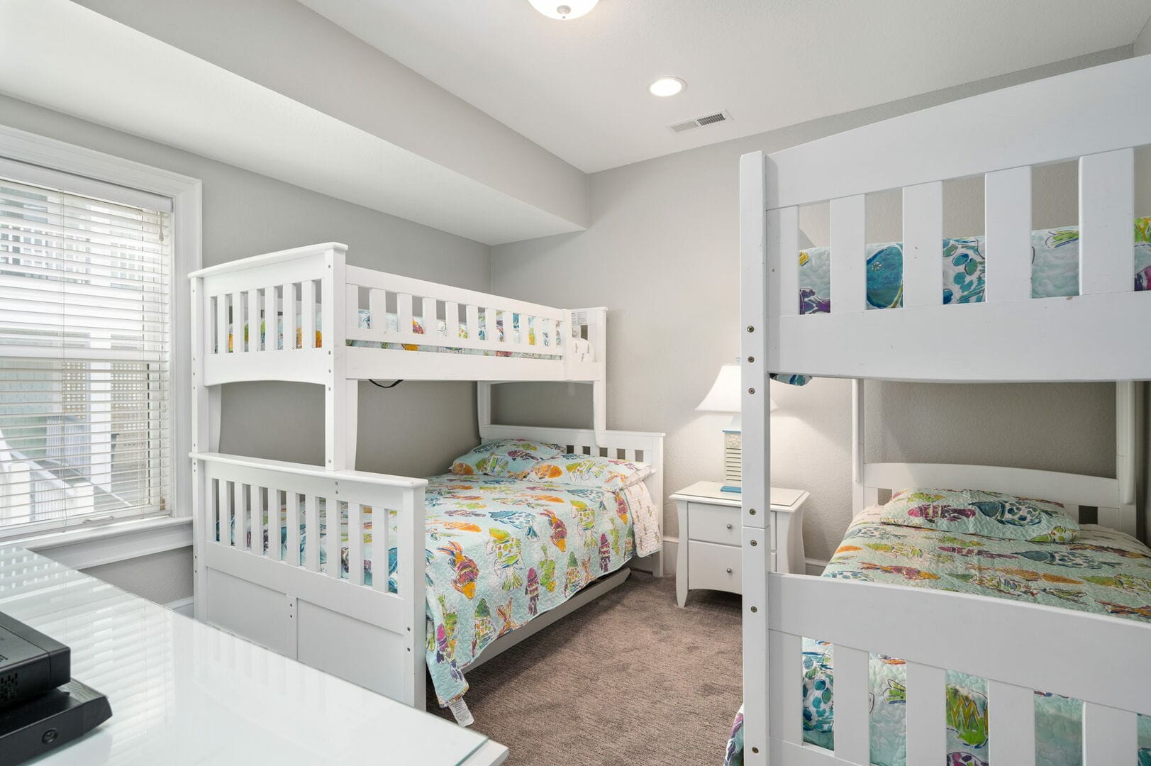Room with white bunk beds.