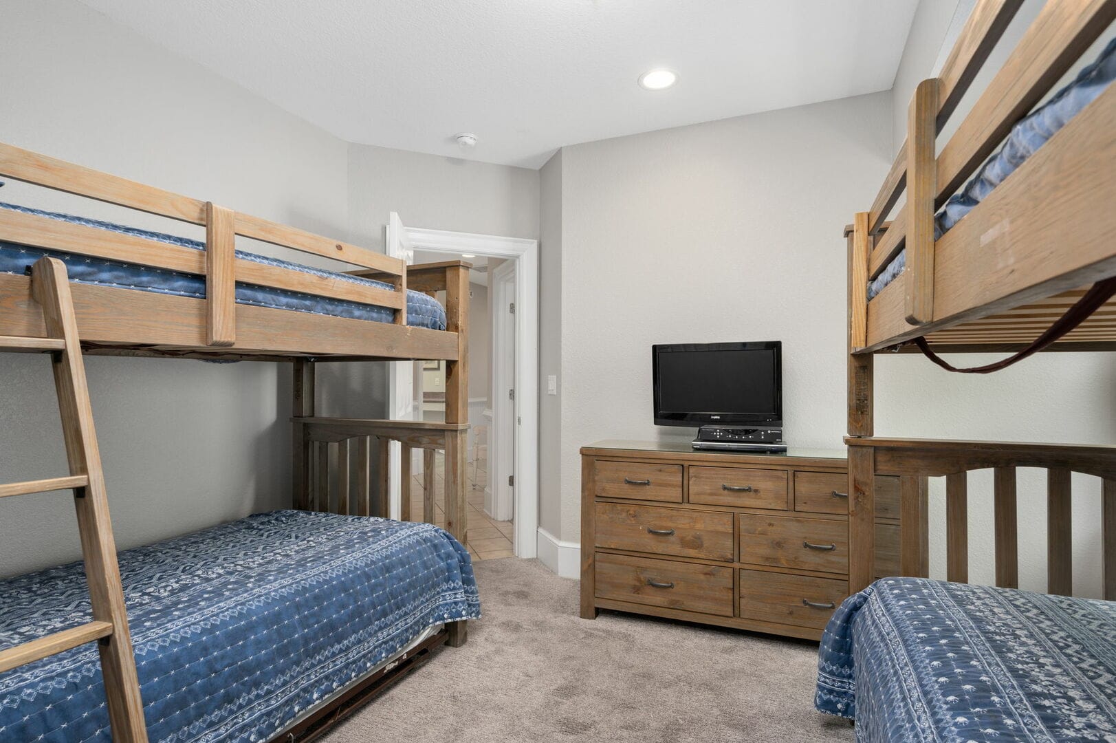 Room with bunk beds, dresser.