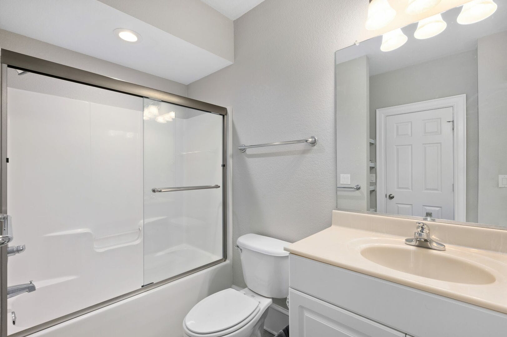 Modern bathroom with shower and sink.