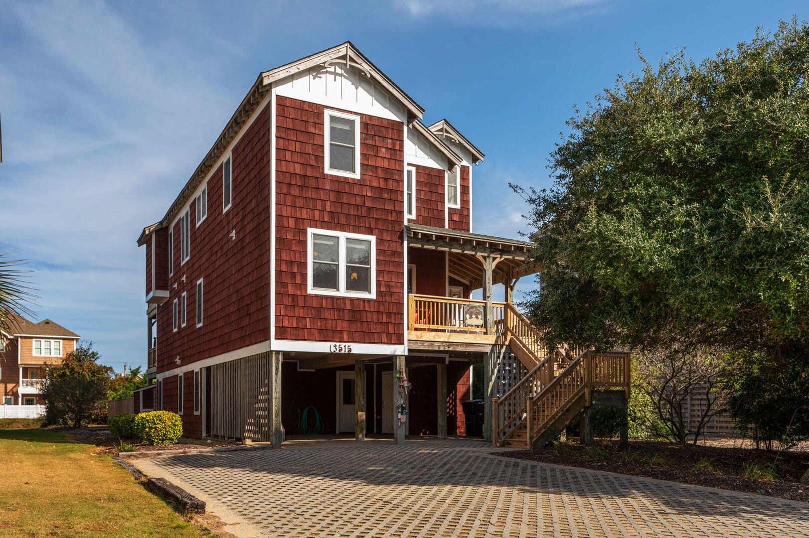 Red wooden house with porch.