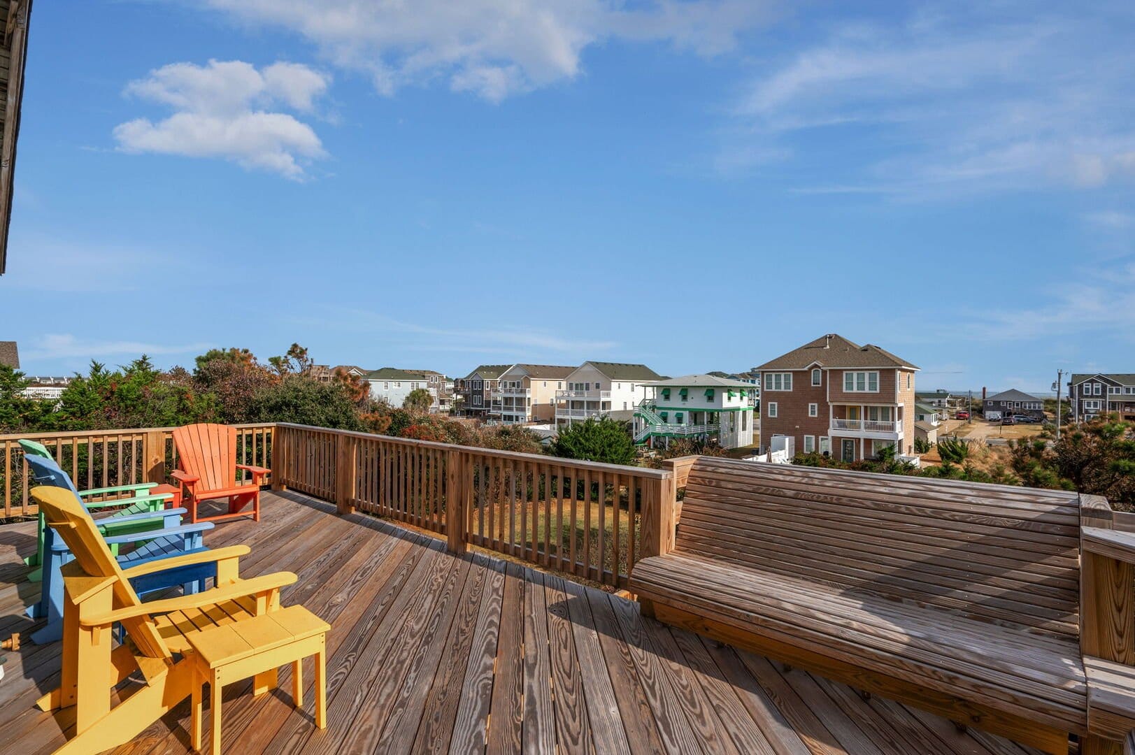 Colorful chairs on wooden deck.