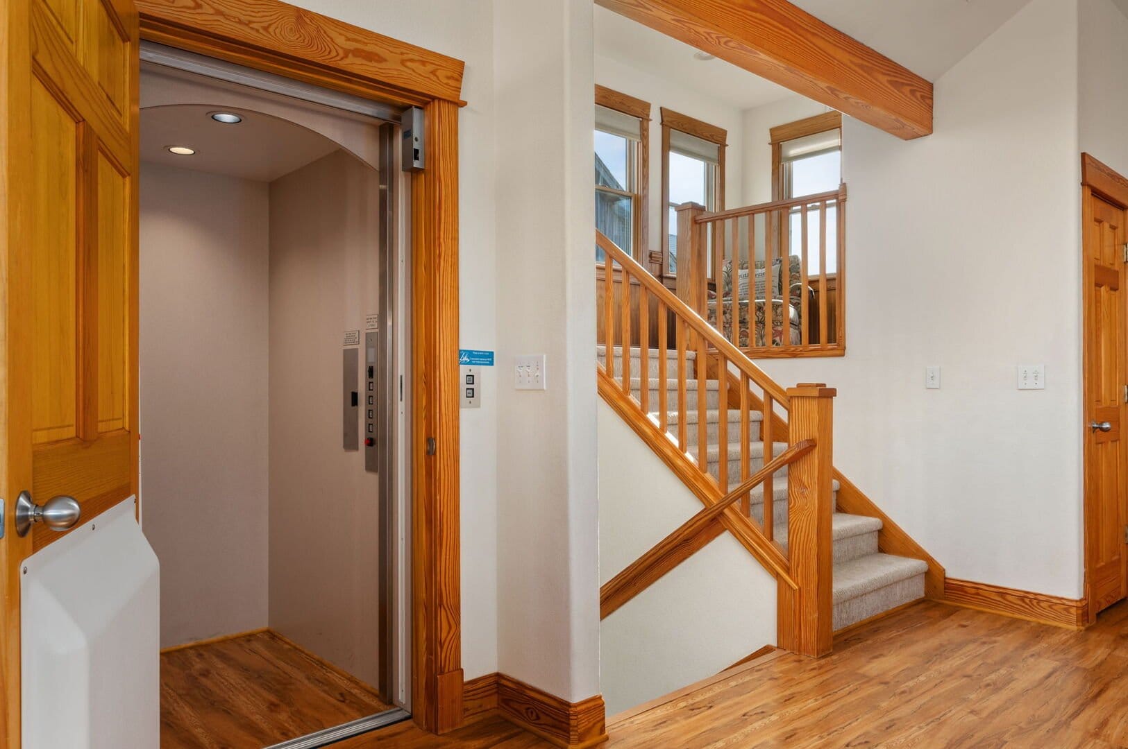 Open elevator and wooden staircase.