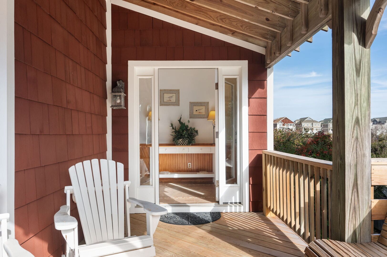 Porch with white Adirondack chair.