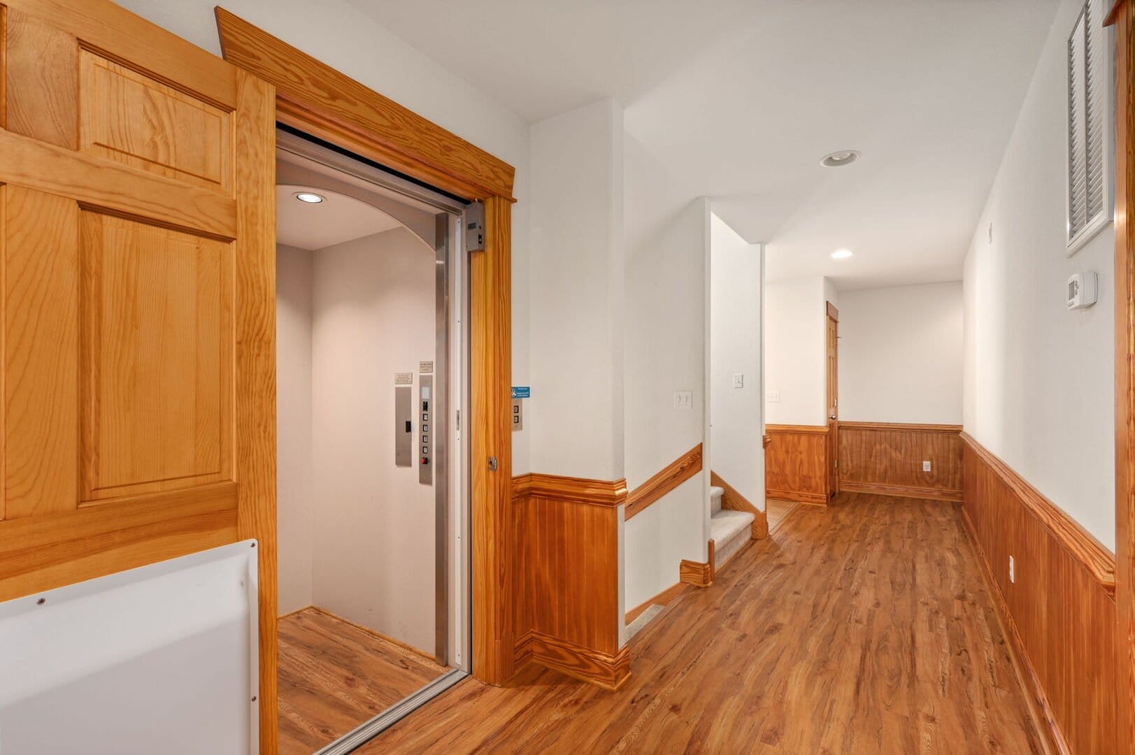 Hallway with open elevator door.